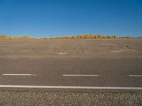 a empty parking lot with no people on it with clear blue skies above the area