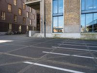 an empty parking lot that has been cleaned in front of an office building with a bicycle rack