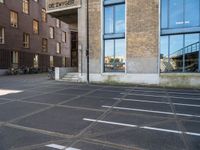 an empty parking lot that has been cleaned in front of an office building with a bicycle rack