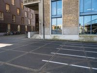 an empty parking lot that has been cleaned in front of an office building with a bicycle rack