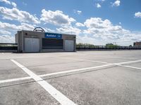 the empty parking lot is empty in the sunny day time and it looks like an old car garage