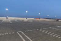 a parking lot is empty during the day in a lit cityscape at night