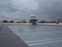 an empty parking lot with a blue door in the rain, with buildings in the background