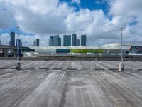 a view of an empty parking lot in front of a big building with tall buildings