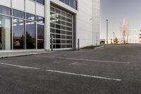 potholes in a parking lot full of water near an office building with glass windows