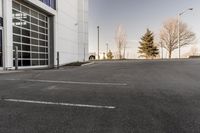 potholes in a parking lot full of water near an office building with glass windows