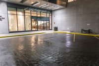 an empty parking lot covered in yellow tape near a building with a closed door and parking meter