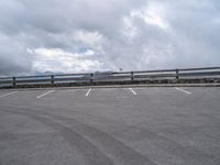 a parking lot with an empty area and mountains in the background next to it,