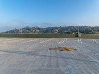 an empty parking lot near the city with yellow lines in it's asphalt surface