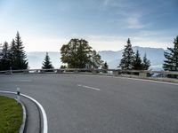 the parking lot for the motorcyclist is empty near trees and buildings, but it has no roads