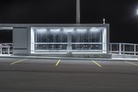 an empty parking lot at night with many lights and benches around it as well as multiple lamps