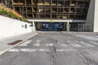 the parking lot outside of an office building is empty, with some signs on the street