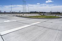 an empty parking lot with a paved surface and white arrows on the curb of it