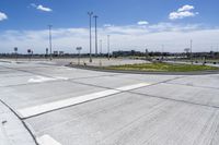 an empty parking lot with a paved surface and white arrows on the curb of it