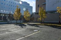 the empty parking lot in front of the school building with blue dots on it is empty