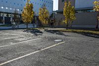 the empty parking lot in front of the school building with blue dots on it is empty