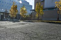 the empty parking lot in front of the school building with blue dots on it is empty