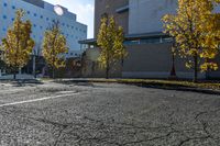 the empty parking lot in front of the school building with blue dots on it is empty