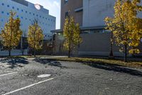 the empty parking lot in front of the school building with blue dots on it is empty