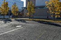 the empty parking lot in front of the school building with blue dots on it is empty