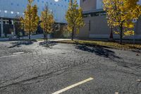 the empty parking lot in front of the school building with blue dots on it is empty