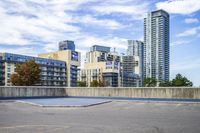 a parking lot that has an empty space with a skate board in it with many buildings behind it