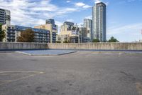 a parking lot that has an empty space with a skate board in it with many buildings behind it