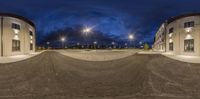 the picture shows a very empty parking lot on a cloudy night with no one at all