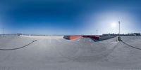 the view from the top of a ramp looking at an empty parking lot in the sun