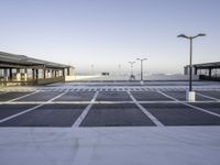 an empty parking lot is seen with tall, buildings in the background - stock photo - images