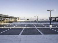 an empty parking lot is seen with tall, buildings in the background - stock photo - images