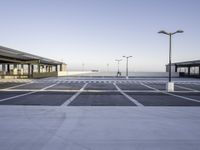 an empty parking lot is seen with tall, buildings in the background - stock photo - images