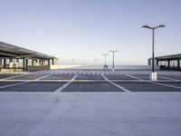 an empty parking lot is seen with tall, buildings in the background - stock photo - images