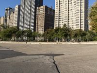 the sky is clear and a parking lot is empty for us to see the city's tall buildings