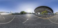 a panorama photo shows the empty parking lot in front of the building in this picture