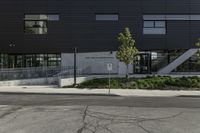 the entrance to an empty parking lot with black walls and windows at a shopping center