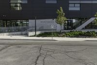 the entrance to an empty parking lot with black walls and windows at a shopping center