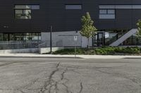 the entrance to an empty parking lot with black walls and windows at a shopping center