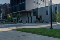 an empty parking lot near a large building with some windows on the side of it