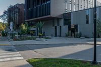 an empty parking lot near a large building with some windows on the side of it