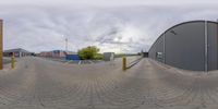 there is a 360 - view of an empty parking lot in a town center, looking back across the road at some buildings