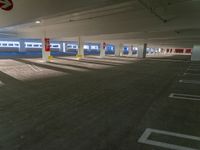 a empty parking lot with three white trains on it's tracks in a building