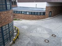 there is an empty parking lot in front of the building with a red sign in it