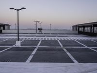 an empty parking lot with no cars parked on it's side and the sky in the background