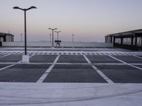 an empty parking lot with no cars parked on it's side and the sky in the background