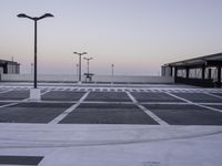 an empty parking lot with no cars parked on it's side and the sky in the background