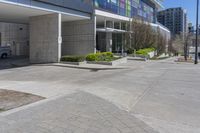 empty parking lot in front of large building in urban setting area with no cars on it