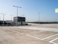 an empty parking lot has signs indicating parking spots and lines on the ground for parking