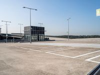 an empty parking lot has signs indicating parking spots and lines on the ground for parking