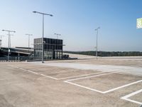 an empty parking lot has signs indicating parking spots and lines on the ground for parking